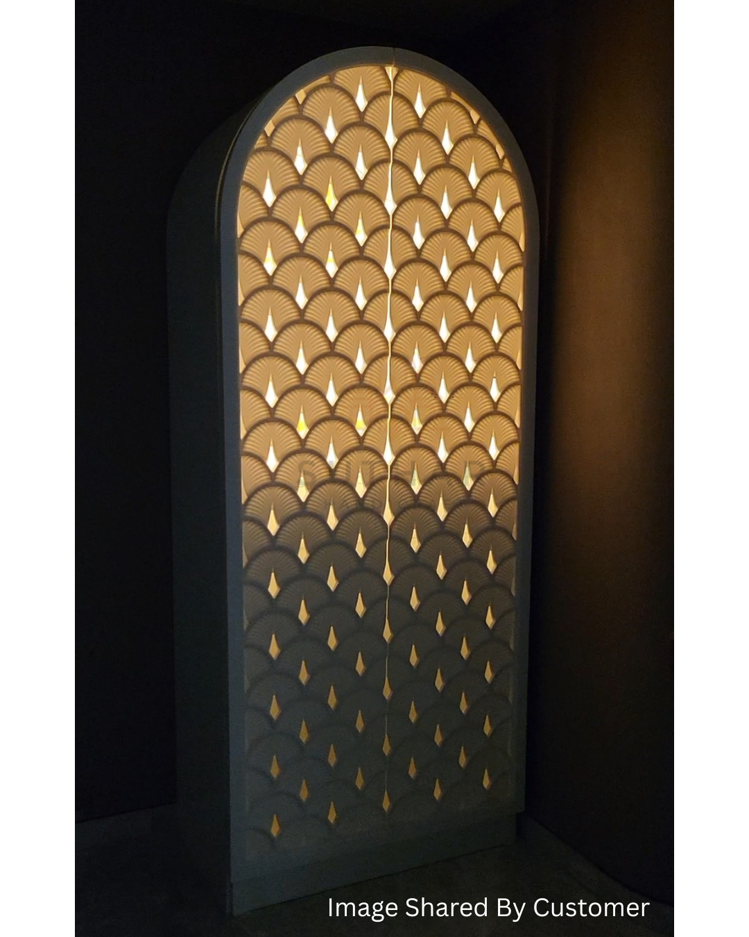 A 5ft arc shaped Corian mandir by Suthar Handicraft shown in a modern living room, glowing with backlit LED light.