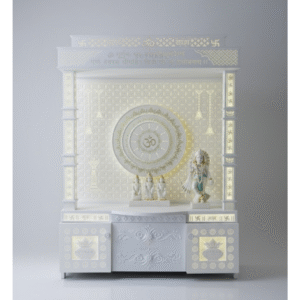 quare Pillar Corian Mandir – The Perfect Blend of Devotion and Design The Square Pillar Corian Mandir by Suthar Handicraft redefines traditional pooja spaces with its elegant craftsmanship and luxurious design. Made entirely from premium Corian solid surface, this mandir offers unmatched durability and a soft, luminous glow that enhances the divine ambiance of your home. The highlight of this mandir is its inside embossed Om design, symbolizing peace, divinity, and the eternal presence of God. 1. Divine Design with Embossed Om Symbol At the heart of this Corian Mandir with Om Design lies a beautifully embossed circular Om pattern that glows subtly under LED illumination. This sacred design represents spiritual harmony and radiates calm energy throughout your home. Whether placed in a dedicated pooja room or your living space, this Handcrafted Corian Mandir becomes a spiritual centerpiece, uplifting both your mood and décor. 2. Elegant Square Pillar Structure The defining feature of this temple is its square pillar design, carved with precision to add structural strength and aesthetic appeal. The symmetrical pillars give this Designer Corian Temple a majestic stance, reminiscent of grand architectural styles seen in Indian temples. The intricate Swastik and floral carvings on the pillars bring auspicious energy, while the LED backlight enhances the intricate detailing. 3. Premium Corian Material for Long-Lasting Quality Built using high-quality Corian (Korean marble finish), the mandir is resistant to stains, moisture, and cracks, making it ideal for long-term use. The smooth, glossy texture is easy to clean and maintain. Every Corian Temple for Home crafted by Suthar Handicraft passes through rigorous quality checks to ensure superior finish and perfection. 4. Spacious and Functional Design Standing 6 feet tall, 2.5 feet wide, and 1 foot deep, this mandir provides ample space for idols of your favorite deities — from Lord Krishna and Ram Darbar to Ganpati and Lakshmi Mata. The lower cabinet offers storage for pooja essentials, incense, and sacred texts. The thoughtful design ensures both functionality and devotion in one elegant piece. 5. Handcrafted Excellence by Suthar Handicraft At Suthar Handicraft, each Handcrafted Corian Mandir is a product of skilled artisans who blend traditional temple art with contemporary design. The precision cutting, glowing backlight, and engraved Sanskrit motifs make every piece unique. The mandir is ready to place and does not require any wall fitting, making it ideal for modern apartments and villas. 6. Why Choose Suthar Handicraft’s Corian Temples 100% Original Corian Solid Surface Customizable Sizes and Designs LED Backlit Panels for Divine Glow Free-Standing, No Fitting Required Elegant and Long-Lasting Finish 7. Perfect for Every Home Whether you’re searching for a Square Pillar Corian Mandir, a Corian Mandir with Om Design, or a Designer Corian Temple that reflects elegance and peace, this model is the perfect fit. The serene white tone and glowing Om design create a sacred corner that inspires mindfulness and devotion.
